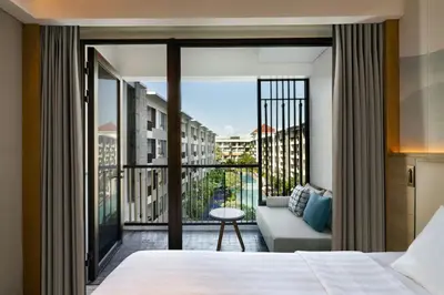 a hotel room with a bed and a large window at Courtyard by Marriott Bali Seminyak Resort in Seminyak
