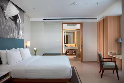 a bedroom with a bed and a desk and a chair at Courtyard by Marriott Bali Seminyak Resort in Seminyak