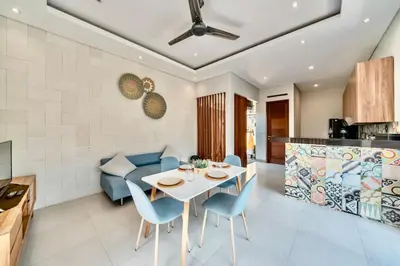 a kitchen and living room with a table and chairs at Exclusive 2BR Villa with bathroom en suite and privat Pool in Kerobokan