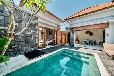 a swimming pool in front of a villa at Exclusive 2BR Villa with bathroom en suite and privat Pool in Kerobokan