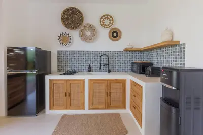 a kitchen with a sink and a black refrigerator at Seminyak Dream 1 bedroom villa with private pool in Seminyak