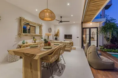 a dining room with a wooden table and chairs at Seminyak Dream 1 bedroom villa with private pool in Seminyak