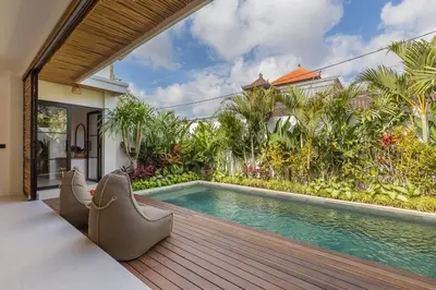 an outdoor deck with a swimming pool in a house at Seminyak Dream 1 bedroom villa with private pool in Seminyak