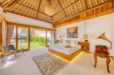 a bedroom with a bed and a couch and a table at Villa Tango - New Luxurious 7BDR Prime Location in Seminyak