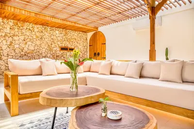 a living room with a white couch and a table at Villa Tango - New Luxurious 7BDR Prime Location in Seminyak