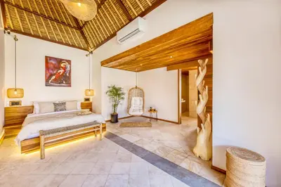 a bedroom with a king sized bed and a wooden ceiling at Villa Tango - New Luxurious 7BDR Prime Location in Seminyak