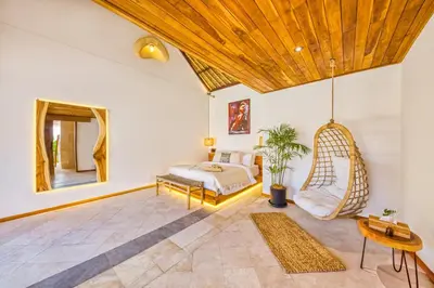 a bedroom with a bed and a swing at Villa Tango - New Luxurious 7BDR Prime Location in Seminyak