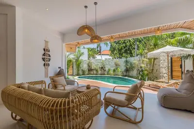 a living room with chairs and a swimming pool at Villa Alamanda Maya Seminyak center 2 bedr with private Pool in Seminyak