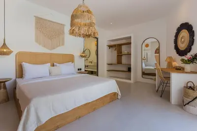 a bedroom with a bed and a table and a mirror at Villa Alamanda Maya Seminyak center 2 bedr with private Pool in Seminyak