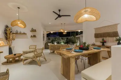 a kitchen and living room with a table and chairs at Villa Alamanda Maya Seminyak center 2 bedr with private Pool in Seminyak