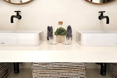 a bathroom with two sinks and two glasses on a counter at Villa Alamanda Maya Seminyak center 2 bedr with private Pool in Seminyak