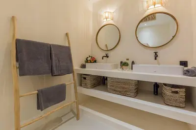 a bathroom with two sinks and a mirror at Villa Alamanda Maya Seminyak center 2 bedr with private Pool in Seminyak