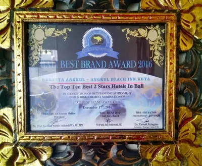 a picture of a best brand award sign in a frame at Angkul Angkul Beach Inn Kuta by Kamara in Kuta
