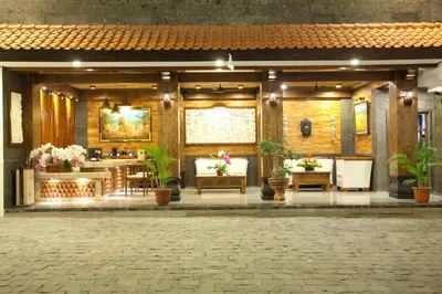 a lobby of a building with flowers and plants at Astagina Resort Villa and Spa in Legian