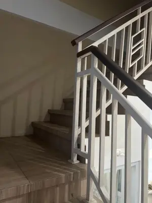 a stairway with a white railing and a stair case at Villa Sipaling in Pesanggaran