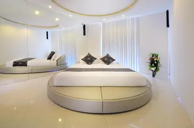 a bedroom with a large bed and a couch at 4BR Villa Minggu - Minggu Villas Seminyak in Seminyak