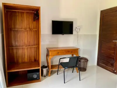 a room with a desk and a television and a chair at St.Regina Bali 3 Bedroom Villa in Nusa Dua
