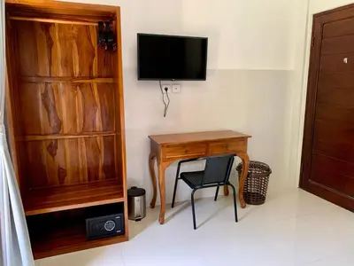 a room with a desk and a tv on a wall at St.Regina Bali 3 Bedroom Villa in Nusa Dua