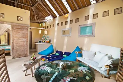 a living room with a couch and a table at Villa Domus Dua in Seminyak
