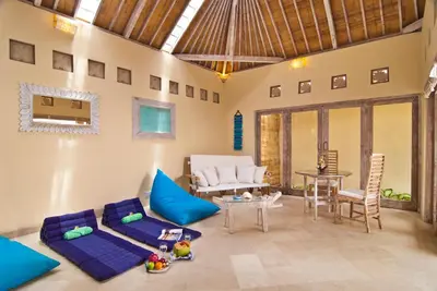 a living room with a couch and a table at Villa Domus Dua in Seminyak
