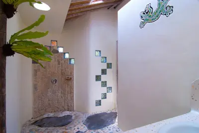 a bathroom with a shower in the corner of a room at Villa Domus Dua in Seminyak