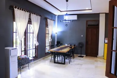 a dining room with a table and some windows at Aiwan Hostel & Luggage storage in Sanur