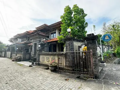 a house with a gate in front of it at Aiwan Hostel & Luggage storage in Sanur