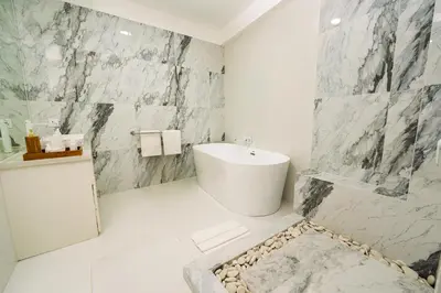 a bathroom with a white tub and a sink at Spacious 3 BR Villa with private pool and Billiards in Seminyak