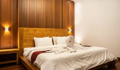 a bedroom with a large bed with white sheets at Winy Estate - Luxury Villa with Rooftop Jacuzzi in Canggu