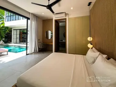a bedroom with a bed and a swimming pool at Three-Bedroom Pool Villa at Anwa Residences in Canggu