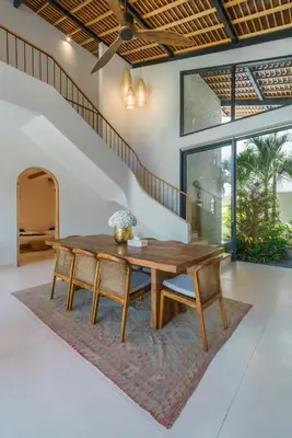 a dining room with a wooden table and chairs at Casa Donilo - 4BR Designer Villa in Canggu in Canggu