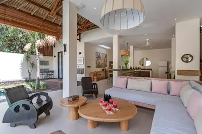 a living room with a couch and a table at Villa Jodoh - Exciting Chic 4BR Stylish Villa Near Seminyak, Perfect for a Trendy Getaway in Kerobokan