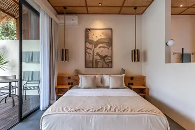 a bedroom with a large bed and a balcony at Villa Jodoh - Exciting Chic 4BR Stylish Villa Near Seminyak, Perfect for a Trendy Getaway in Kerobokan
