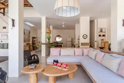 a living room with a couch and a table at Villa Jodoh - Exciting Chic 4BR Stylish Villa Near Seminyak, Perfect for a Trendy Getaway in Kerobokan