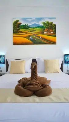 a towel animal is sitting on a bed at Balian Surf Club in Legian