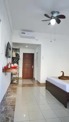 a bedroom with a bed and a ceiling fan at Balian Surf Club in Legian