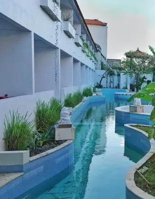 a swimming pool in the middle of a building at Balian Surf Club in Legian