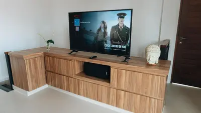 a flat screen tv sitting on top of a wooden entertainment center at Budha Manis Villa in Kerobokan