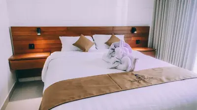 a bedroom with a bed with towels on it at Budha Manis Villa in Kerobokan