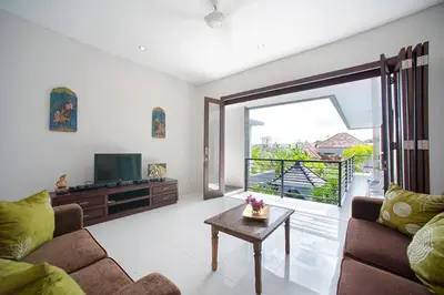 a living room with a couch and a television at Villa Penelopy in Seminyak