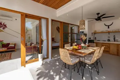 a kitchen and dining room with a table and chairs at Cosy 2bd Chic Villa with Private Pool in Central Location in Kerobokan
