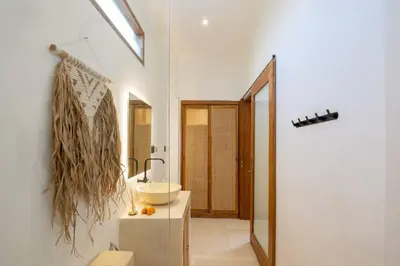 a bathroom with a sink and a mirror at Cosy 2bd Chic Villa with Private Pool in Central Location in Kerobokan