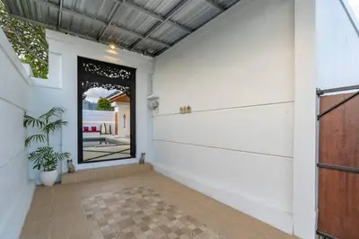 a hallway with white walls and a large doorway at Cosy 2bd Chic Villa with Private Pool in Central Location in Kerobokan