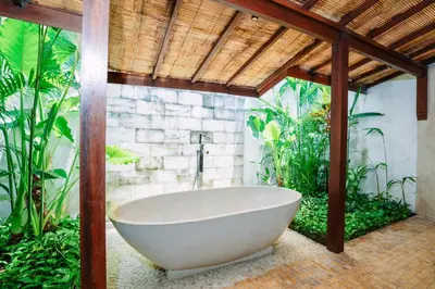 a bath tub in a bathroom with plants at Villa Cira - 5 Bedrooms Private Villa Next to Seminyak in Seminyak