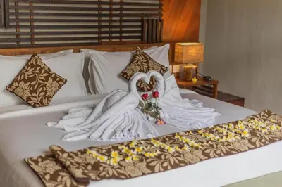 a bed with two swans made out of towels at Mezzanine Industrial 1 Bedroom Private Villa in Seminyak in Seminyak