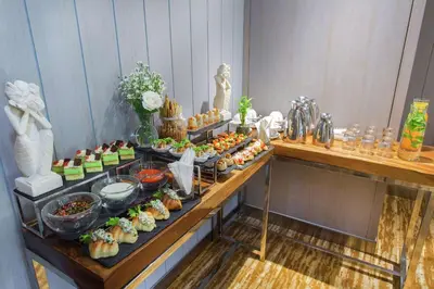 a buffet of food on a table in a room at Hilton Garden Inn Bali Ngurah Rai Airport in Kuta