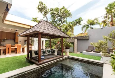 a gazebo next to a pool in a backyard at Buddha Beach Villa Seminyak in Seminyak