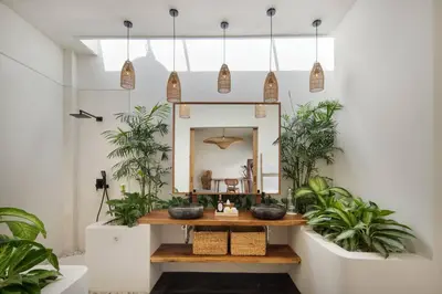 a bathroom with plants and a vanity with a mirror at Villa Pawikan Gorgeous 4 beds villa in the heart of Seminyak in Seminyak