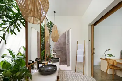 a living room with potted plants and a table at Villa Pawikan Gorgeous 4 beds villa in the heart of Seminyak in Seminyak