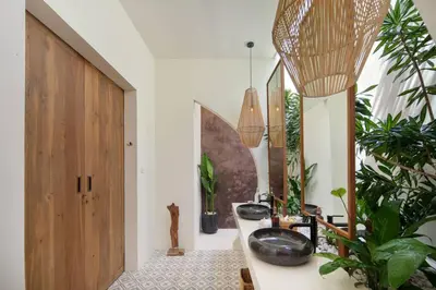 a bathroom with two sinks and potted plants at Villa Pawikan Gorgeous 4 beds villa in the heart of Seminyak in Seminyak